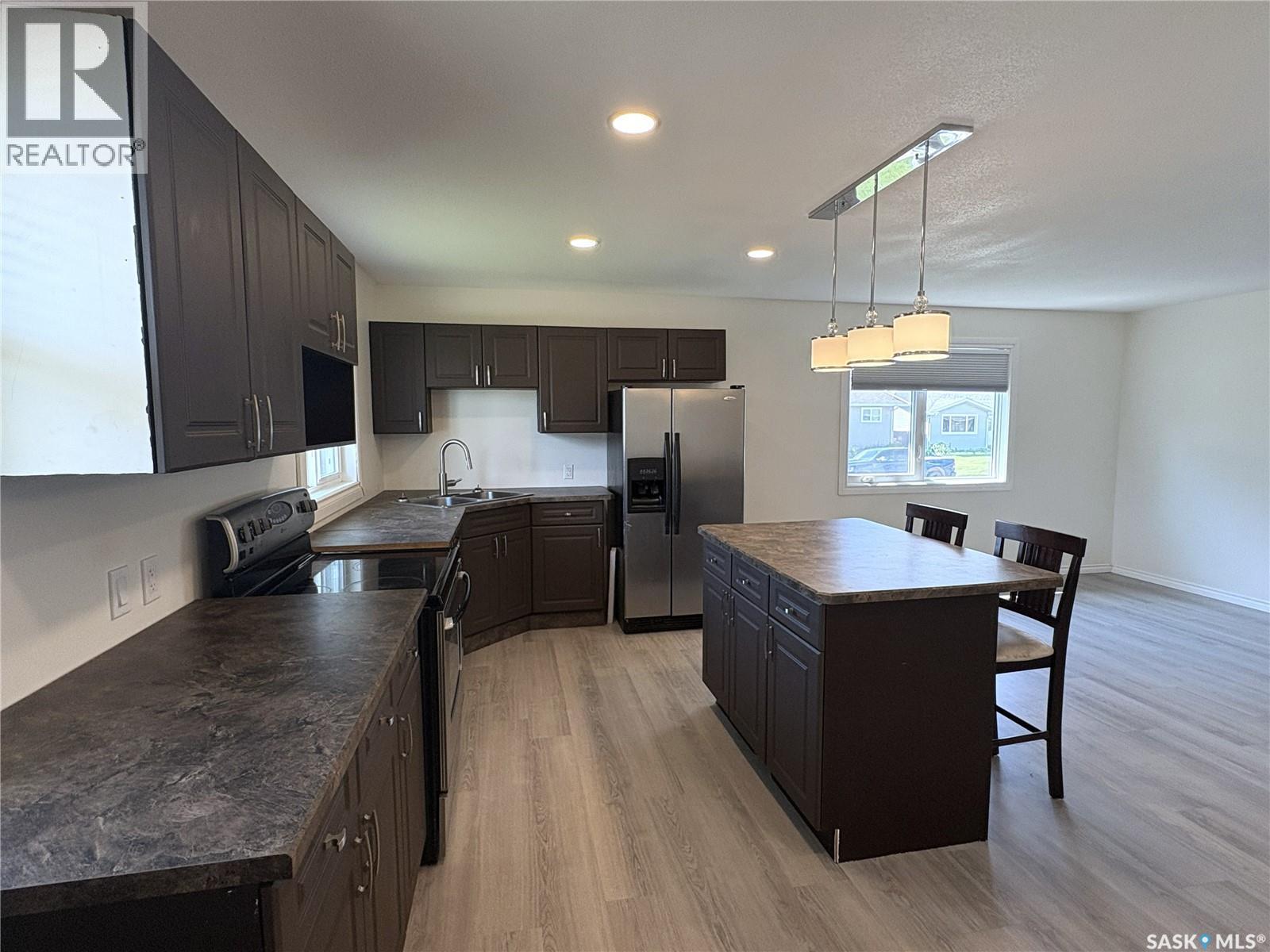 27 Calvert Crescent, Lanigan, SK - Indoor Photo Showing Kitchen With Double Sink