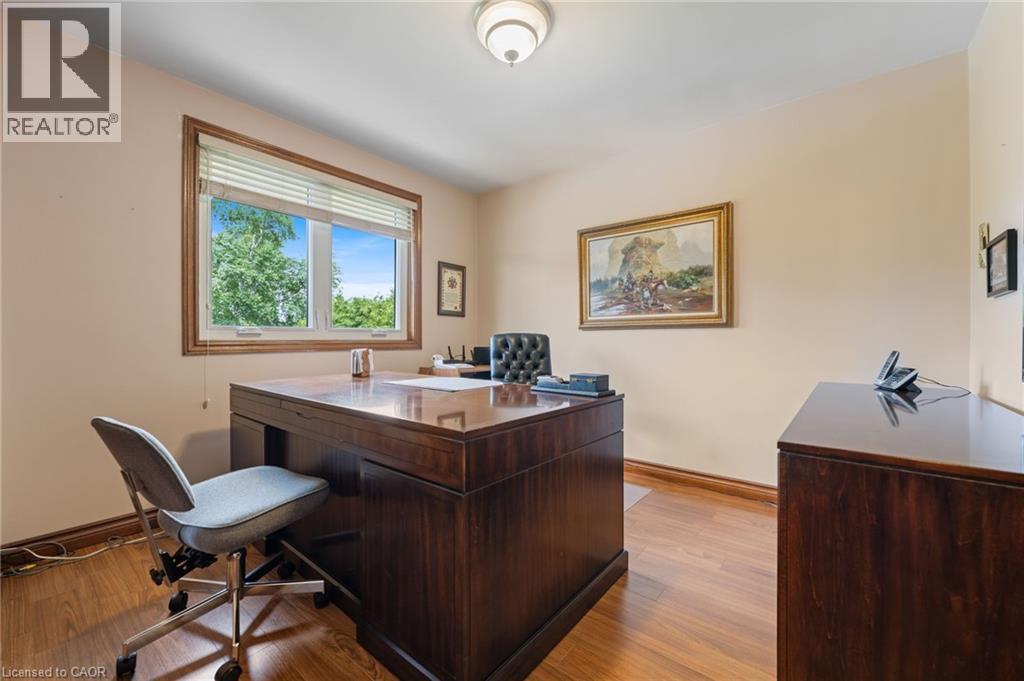 Room featuring wood-finish flooring, a window with horizontal blinds, and neutral-toned walls - 7 Thomson Road, Simcoe, ON - Indoor Photo Showing Office
