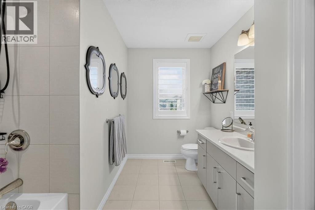Full bathroom featuring a single vanity, integrated sink, and white countertop - 87 Boyd Boulevard, Thamesford, ON - Indoor Photo Showing Bathroom