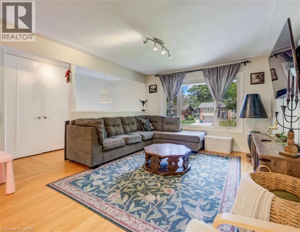Living room featuring light wood-finish flooring, white walls, and a large window with exterior visibility - 209 Willowdale Avenue Unit# Upper, Waterloo, ON - Indoor Photo Showing Living Room