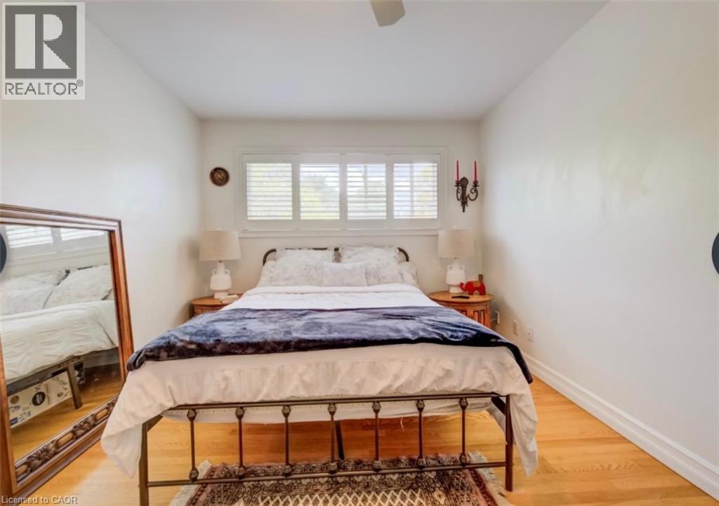 Hardwood flooring complements white walls and trim - 209 Willowdale Avenue Unit# Upper, Waterloo, ON - Indoor Photo Showing Bedroom