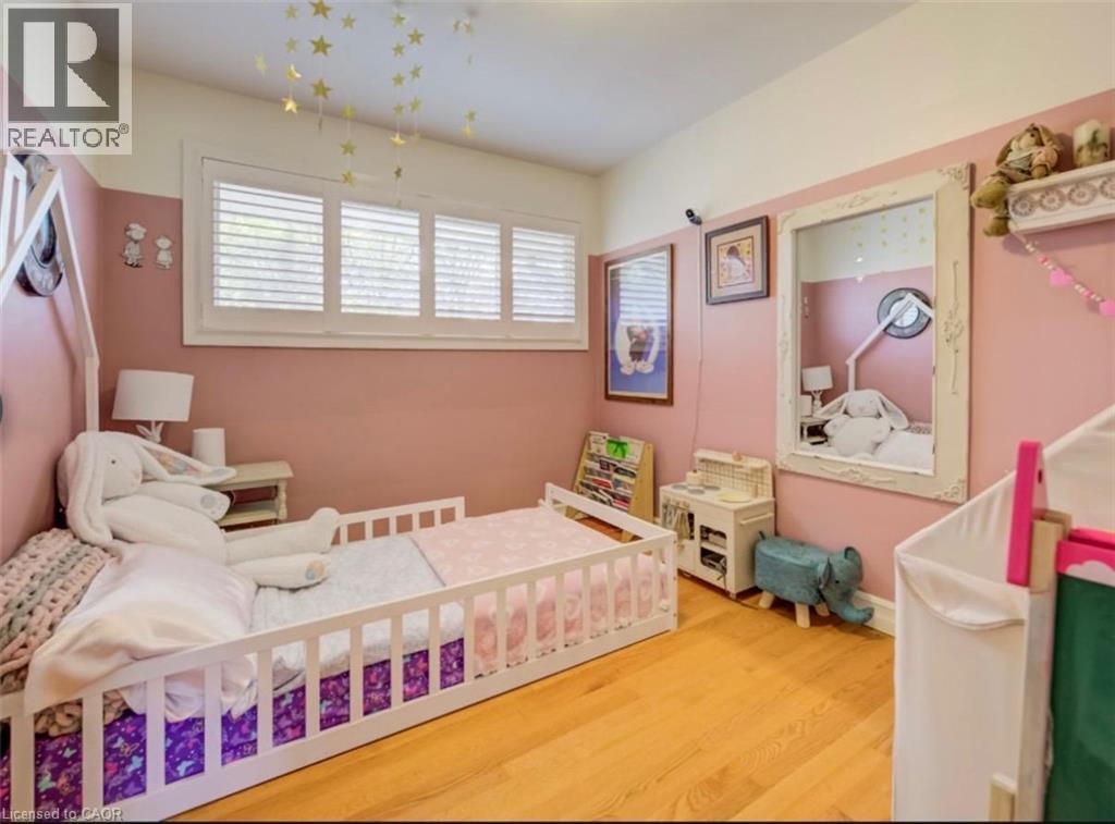 Room featuring hardwood flooring and white plantation shutters - 209 Willowdale Avenue Unit# Upper, Waterloo, ON - Indoor Photo Showing Bedroom