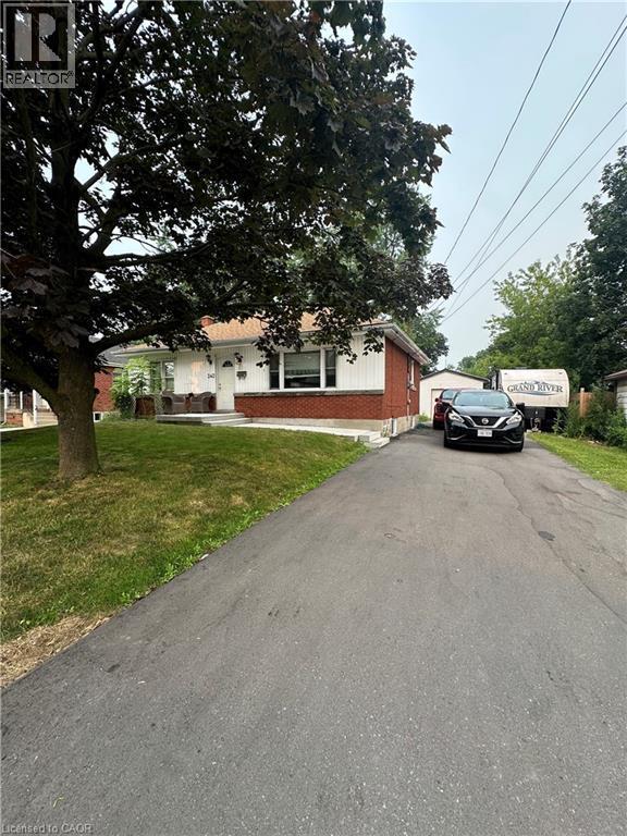 Brick and siding exterior featuring a covered front porch and a paved driveway - 240 West 2Nd Street, Hamilton, ON - Outdoor