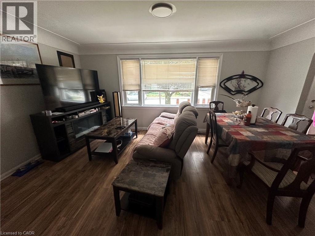 Open-concept living and dining area featuring wood-finish flooring throughout - 240 West 2Nd Street, Hamilton, ON - Indoor Photo Showing Living Room