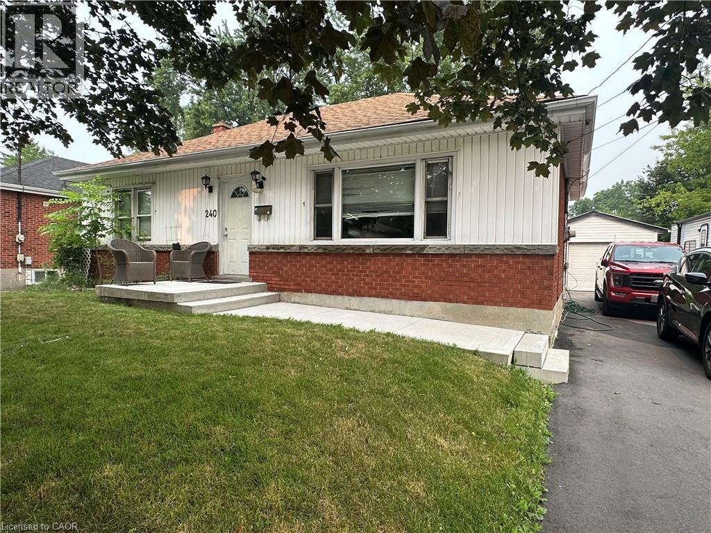 Single-story residence featuring a brick and white vertical siding facade - 240 West 2Nd Street, Hamilton, ON - Outdoor