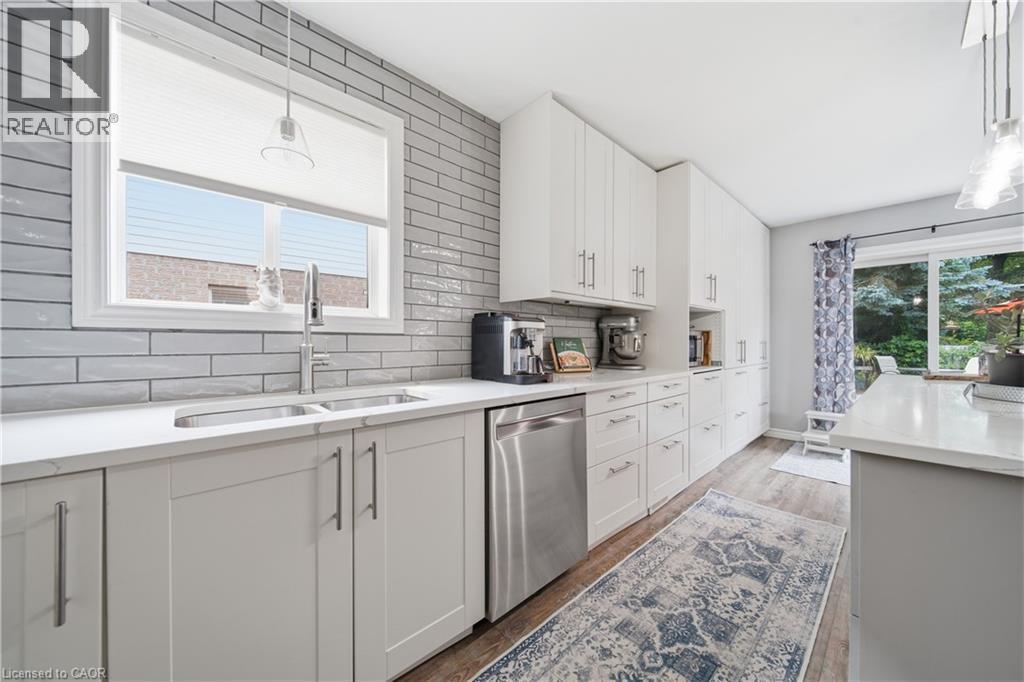 Modern kitchen featuring white shaker cabinetry and stainless-steel appliances - 79 Beaverbrook Crescent, Cambridge, ON - Indoor Photo Showing Kitchen With Double Sink