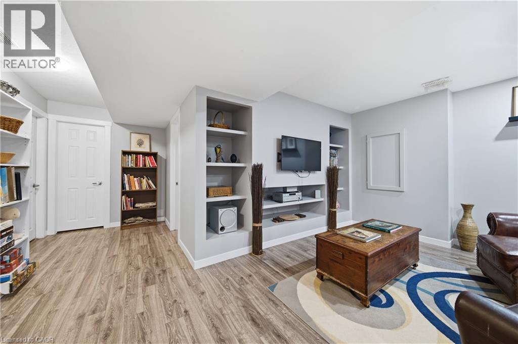 Recreational area featuring wood-finish flooring, recessed lighting, and a built-in media center with shelving - 79 Beaverbrook Crescent, Cambridge, ON - Indoor