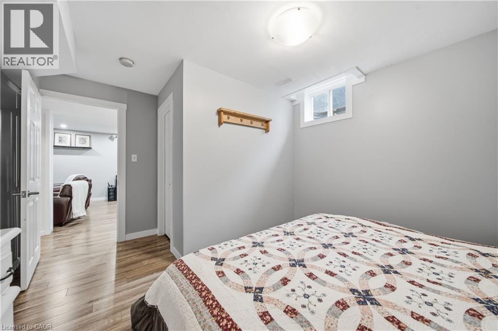 Bedroom featuring neutral wall tones, wood-finish flooring, a window, and a flush-mount ceiling light - 79 Beaverbrook Crescent, Cambridge, ON - Indoor Photo Showing Bedroom