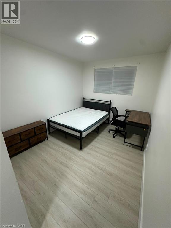 Room featuring light wood-finish flooring, white painted walls, and a ceiling-mounted light fixture - 145 Macgregor Crescent Unit# 8 (R1), Waterloo, ON - Indoor Photo Showing Other Room