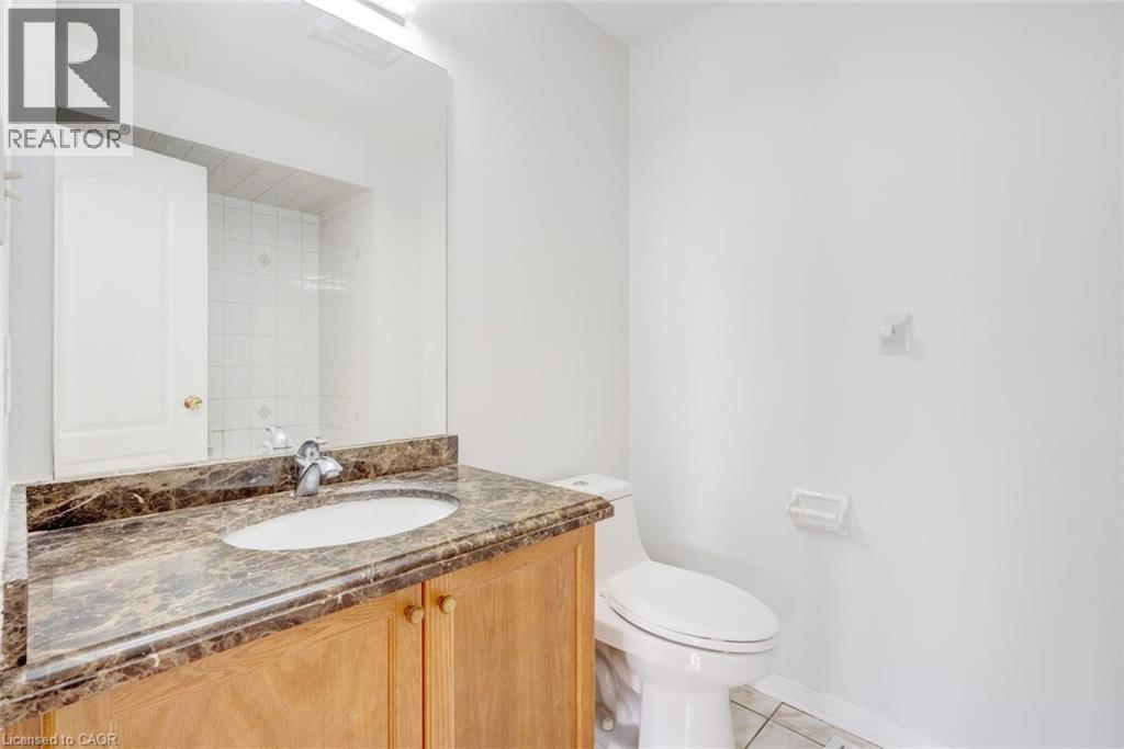 Vanity with a brown marbled countertop and an integrated white oval sink - 5 Freshspring Drive, Brampton, ON - Indoor Photo Showing Bathroom