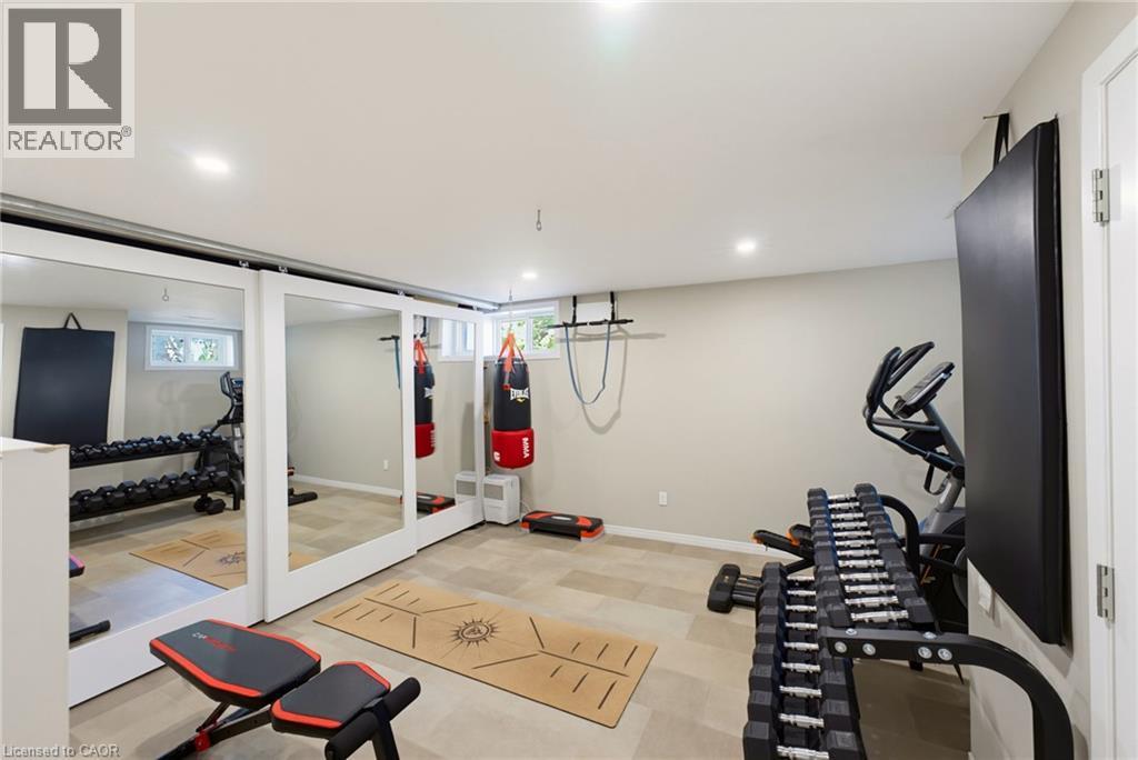 Dedicated fitness space featuring recessed lighting, light-toned wall paint, and durable tile flooring - 8430 Road 146, Listowel, ON - Indoor Photo Showing Gym Room