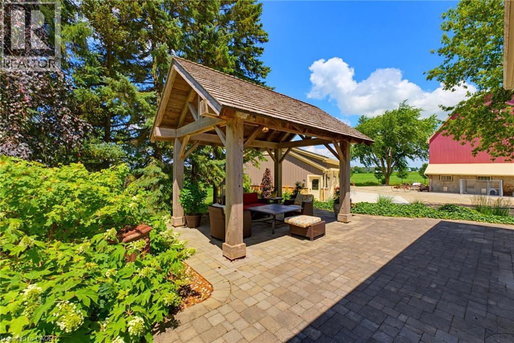 Outdoor wood gazebo featuring a cedar shake roof and structural timber posts - 8430 Road 146, Listowel, ON - Outdoor