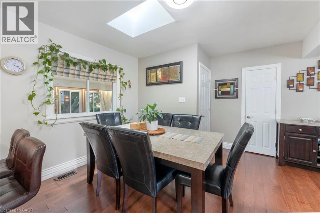 Dining area featuring a skylight and wood-finish flooring - 1063 Joan Drive, Burlington, ON - Indoor Photo Showing Dining Room