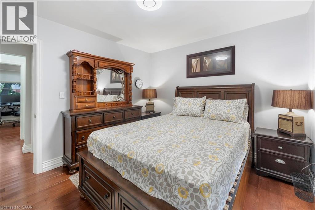 Bedroom featuring wood-finish flooring, light gray walls, and recessed ceiling lighting - 1063 Joan Drive, Burlington, ON - Indoor Photo Showing Bedroom