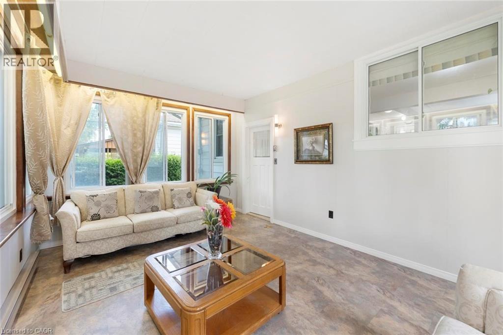 Living area featuring wood-finish flooring and white painted walls - 1063 Joan Drive, Burlington, ON - Indoor Photo Showing Living Room