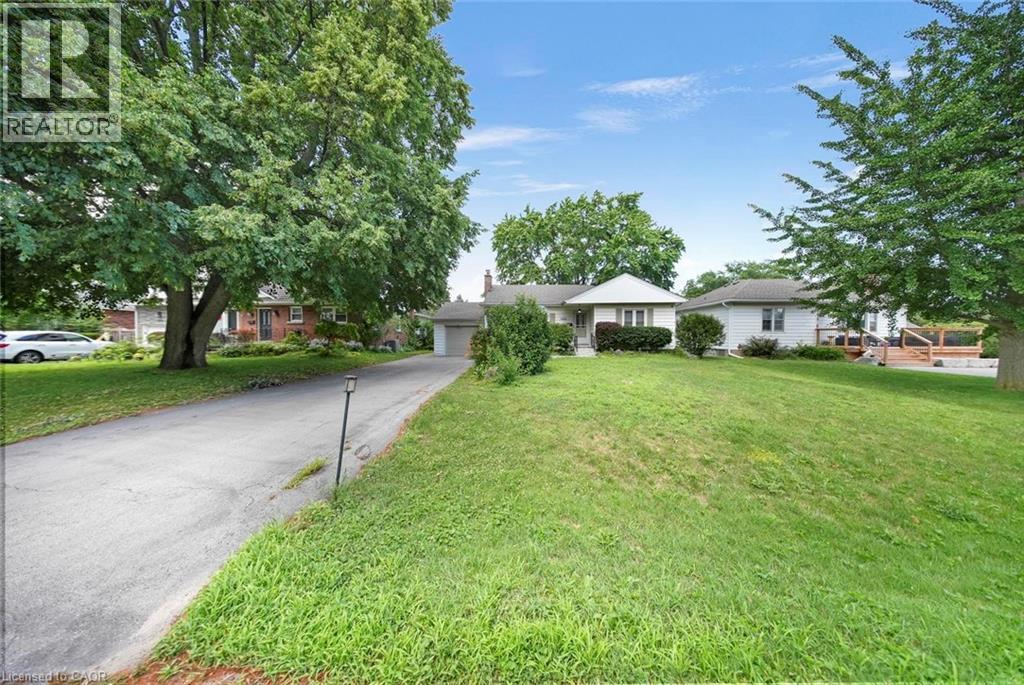 Ranch-style residence featuring a white exterior and a gabled roofline - 1063 Joan Drive, Burlington, ON - Outdoor