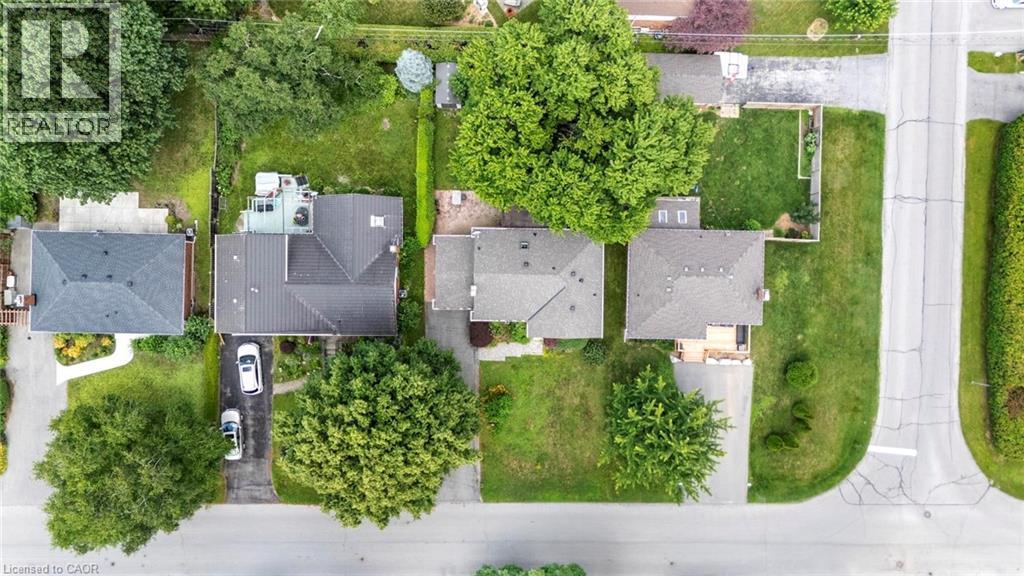 Aerial perspective showcasing a property with a paved driveway, mature trees, and a spacious green lawn - 1063 Joan Drive, Burlington, ON - Outdoor With View