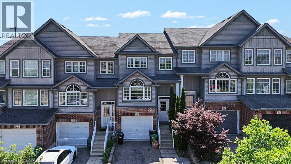 Three-story townhome featuring a mixed-material facade of brick and horizontal siding - 60 Featherstone Street, Kitchener, ON - Outdoor With Facade