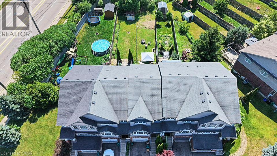 Townhome property featuring a shingled roof and multiple dormer windows - 60 Featherstone Street, Kitchener, ON - Outdoor With View