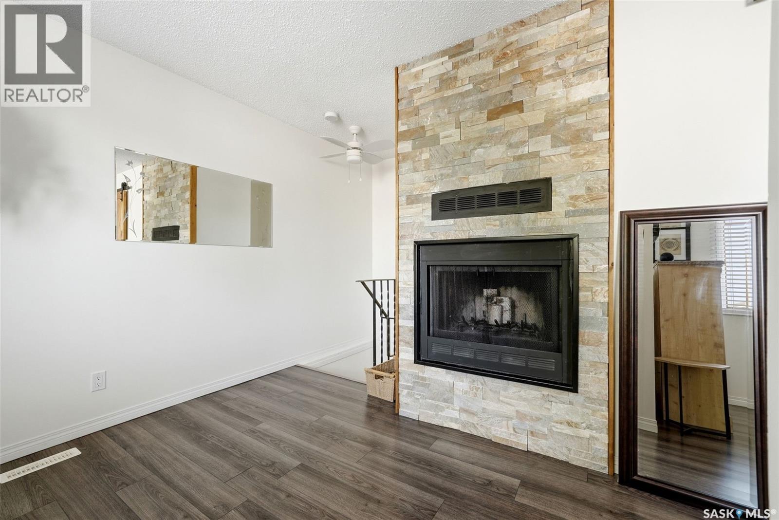 82 Cedar Meadow Drive, Regina, SK - Indoor Photo Showing Living Room With Fireplace
