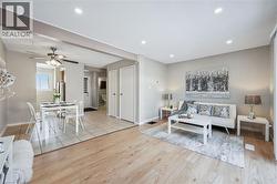Living area featuring wood-finish flooring, recessed lighting, and neutral wall tones - 