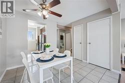 Dining area featuring tile flooring, a ceiling fan with light fixture, and neutral wall paint - 