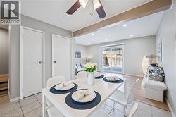 Open-concept dining area featuring tiled flooring, a decorative ceiling fan, and recessed lighting - 