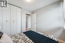 Interior room featuring light gray walls and wood-finish flooring - 