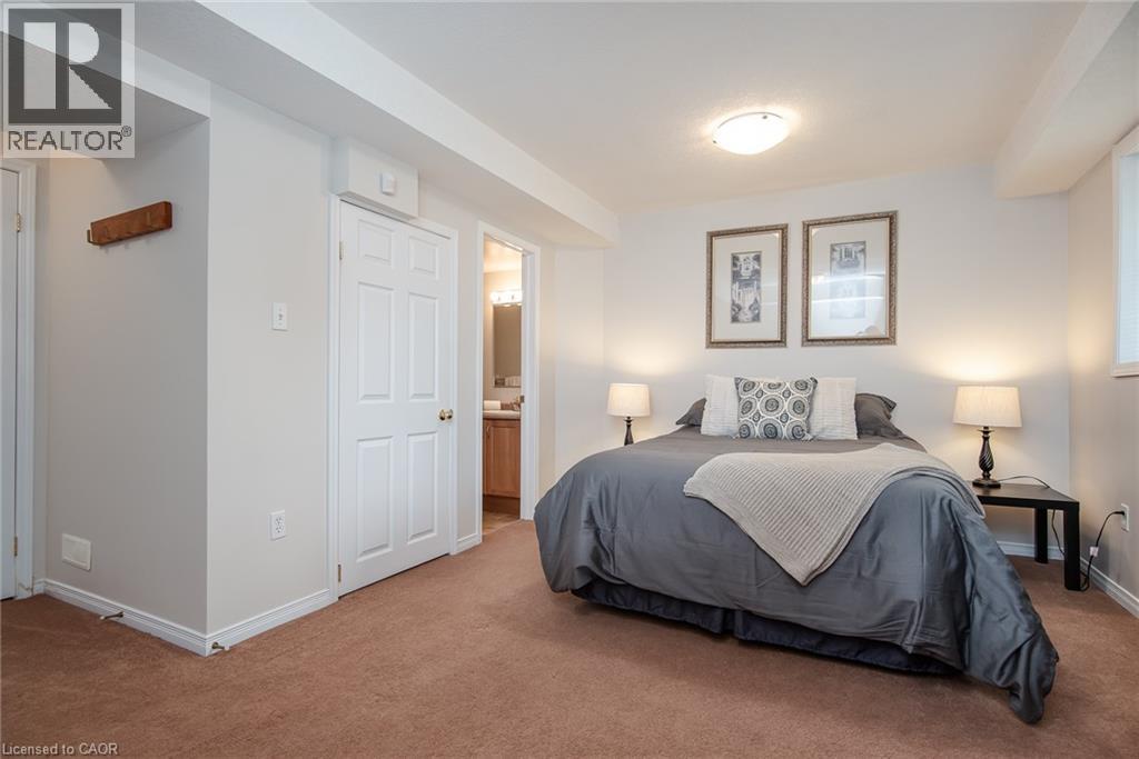 Carpeted bedroom featuring recessed lighting, a window, and a paneled door - 38 David Bergey Drive, Kitchener, ON - Indoor Photo Showing Bedroom