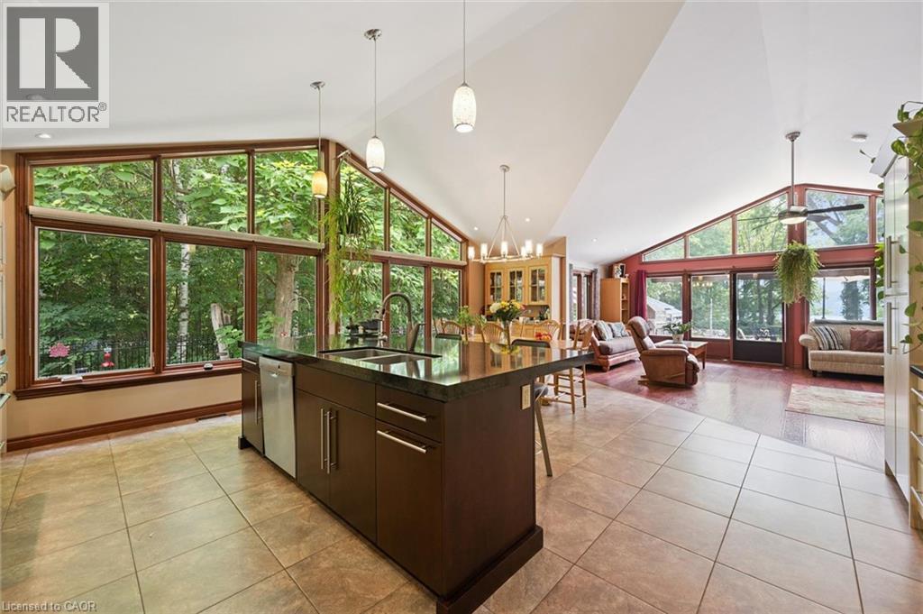 Open-concept living area with a vaulted ceiling and expansive window walls - 410 Avenue Road, Cambridge, ON - Indoor