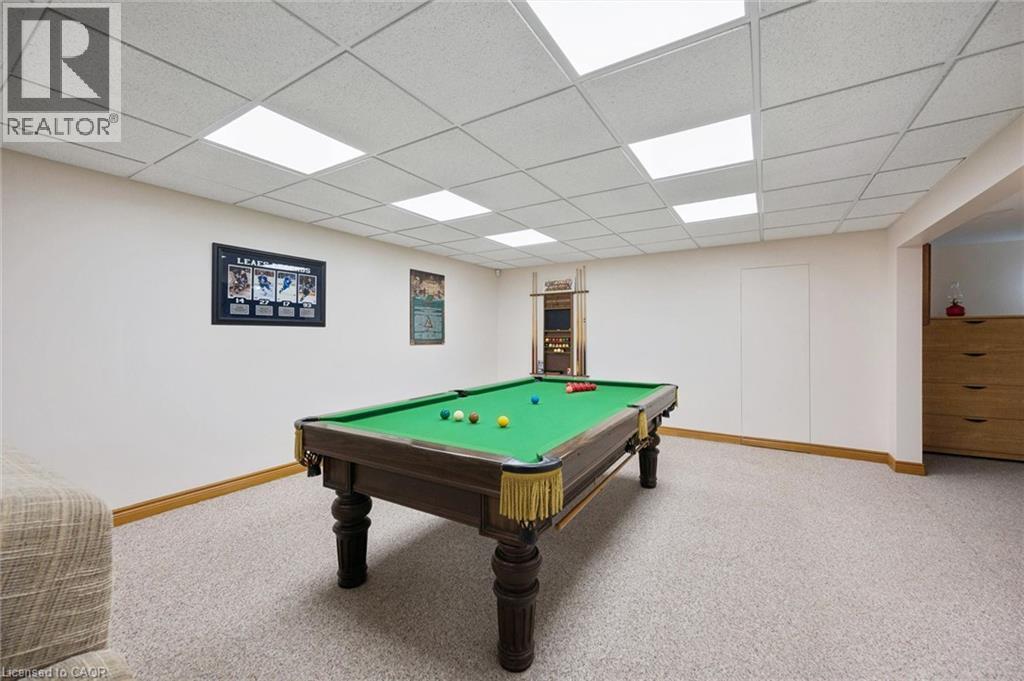 Spacious recreation area featuring with detailed Brunswick billiard table, light toned Berber carpeting, drop ceiling with integrated LED flat panel lighting system - 410 Avenue Road, Cambridge, ON - Indoor Photo Showing Other Room
