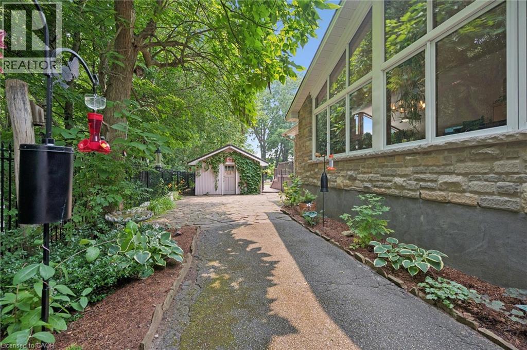 Pass through driveway to the workshop features beautifully landscaped gardens with irrigation system - 410 Avenue Road, Cambridge, ON - Outdoor