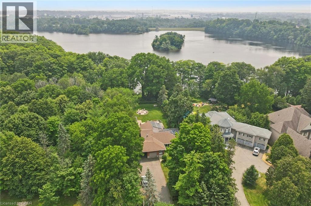 Aerial perspective showcasing a property nestled within abundant mature trees, offering a private setting - 410 Avenue Road, Cambridge, ON - Outdoor With Body Of Water With View