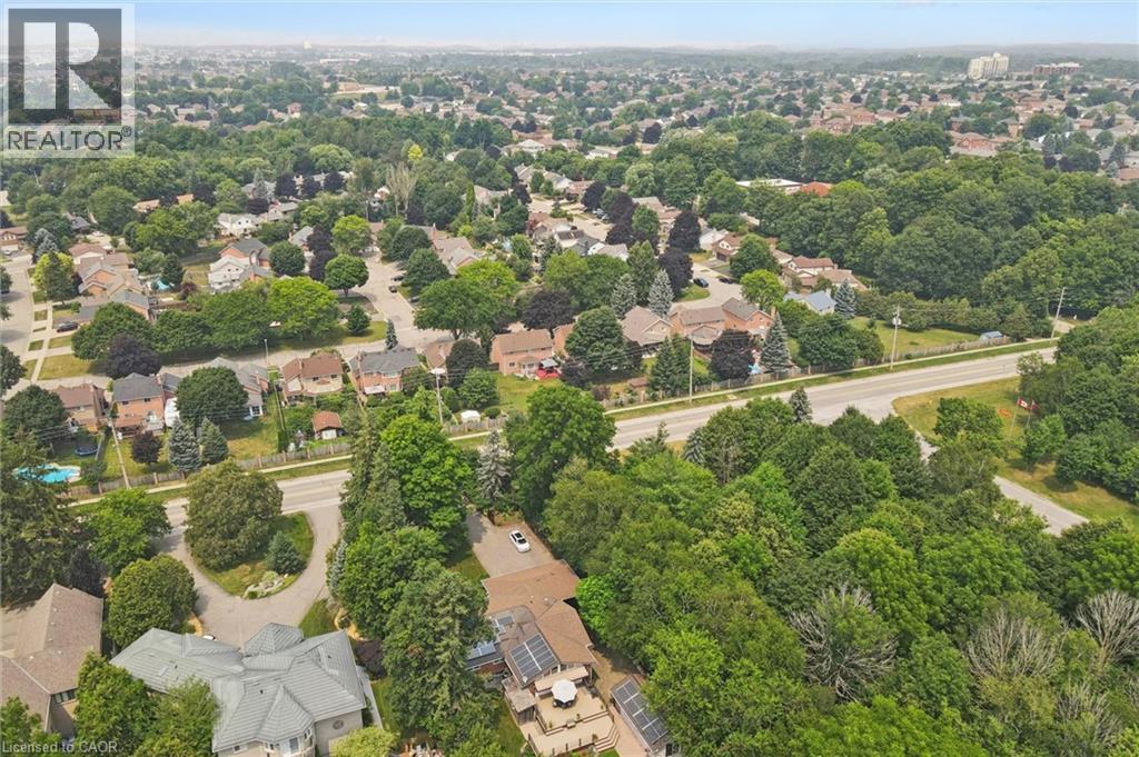 Aerial perspective showcasing a residential area with mature tree coverage with no neighbour to the east side of the property - 410 Avenue Road, Cambridge, ON - Outdoor With View