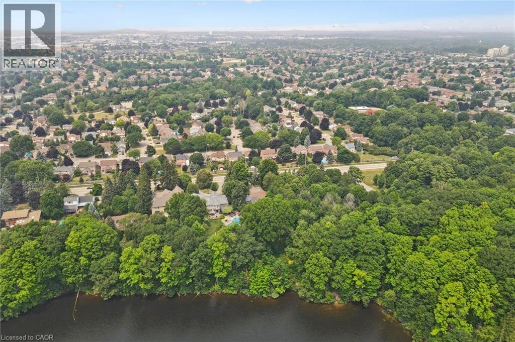 Expansive aerial view showcasing a residential area with extensive tree coverage and a prominent body of water in the foreground - 410 Avenue Road, Cambridge, ON - Outdoor With View