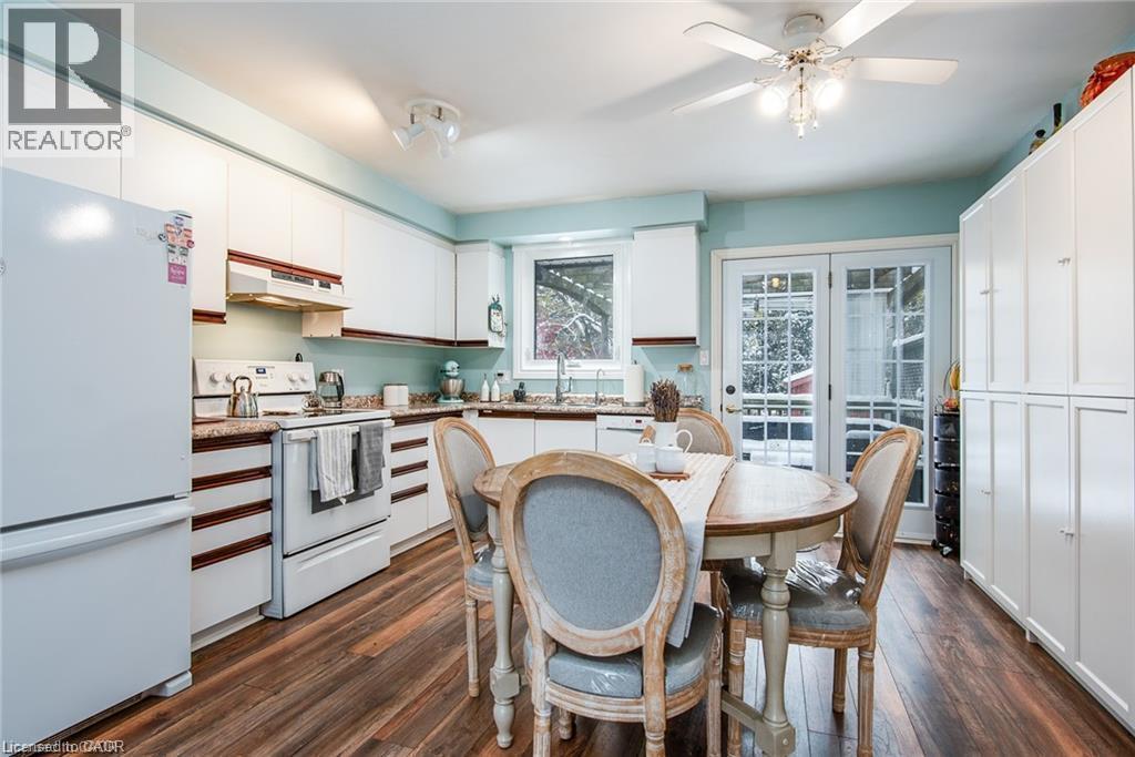 Kitchen featuring white cabinetry, wood-finish flooring, and light blue wall tones - 67 Pinemeadow Crescent, Waterloo, ON - Indoor