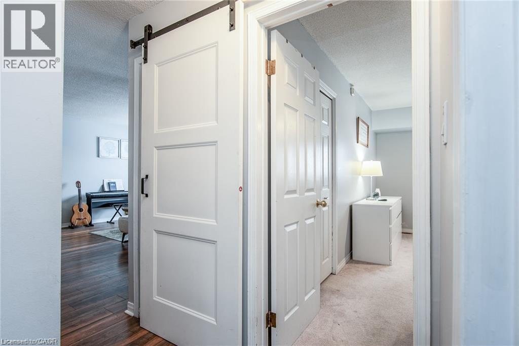 Modern barn door with black hardware - 67 Pinemeadow Crescent, Waterloo, ON - Indoor Photo Showing Other Room