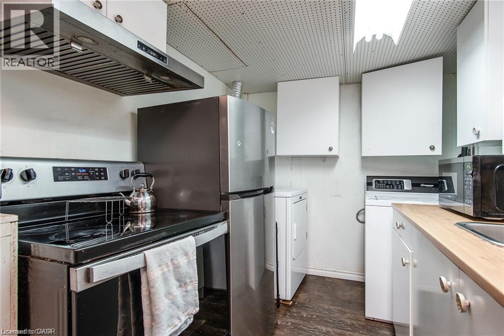 Compact kitchen and laundry area featuring stainless steel appliances - 67 Pinemeadow Crescent, Waterloo, ON - Indoor Photo Showing Kitchen