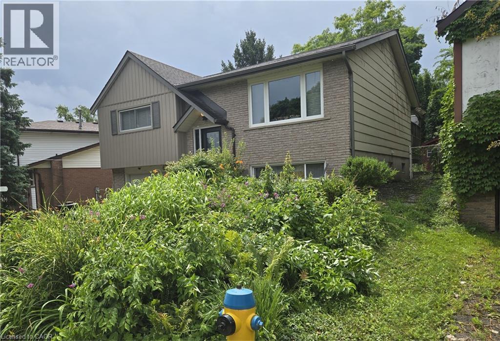 Split-level residence featuring a brick facade and horizontal siding accents - 67 Pinemeadow Crescent, Waterloo, ON - Outdoor