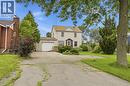 Traditional two-story home with light-toned siding and a gable roof - 834 Mohawk Road E, Hamilton, ON  - Outdoor 