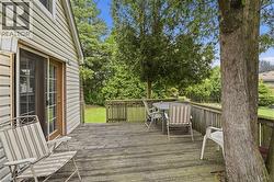 Expansive wood deck with a built-in wood railing, offering direct access to the backyard through a sliding glass door -