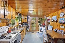 Kitchen featuring wood paneling, wood-finish cabinetry, and French doors -