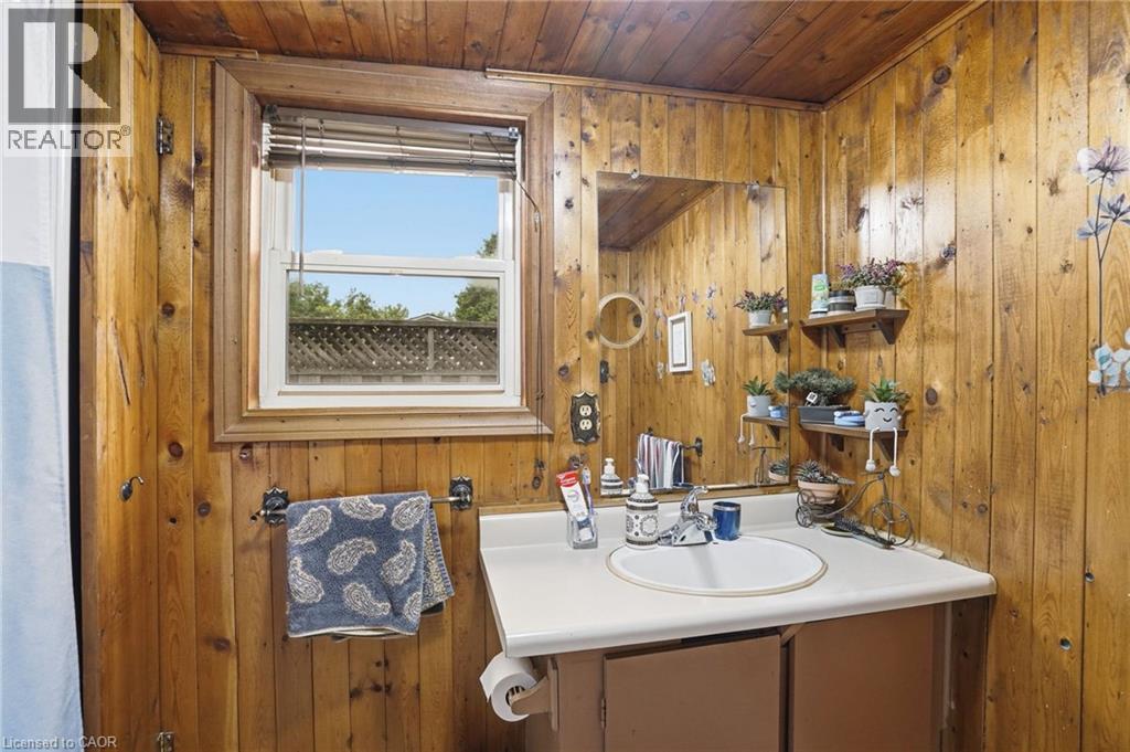 Bathroom featuring wood-paneled walls and ceiling - 834 Mohawk Road E, Hamilton, ON - Indoor