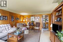 Living area with natural wood paneling -