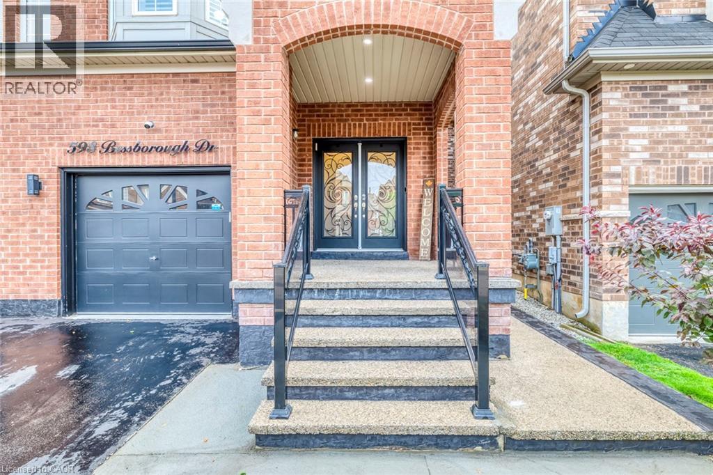 Brick facade entrance featuring double glass-insert doors and an arched portico - 598 Bessborough Drive, Milton, ON - Outdoor
