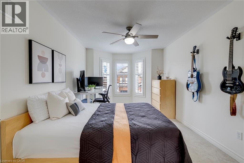 Recessed bay windows with plantation shutters - 598 Bessborough Drive, Milton, ON - Indoor Photo Showing Bedroom