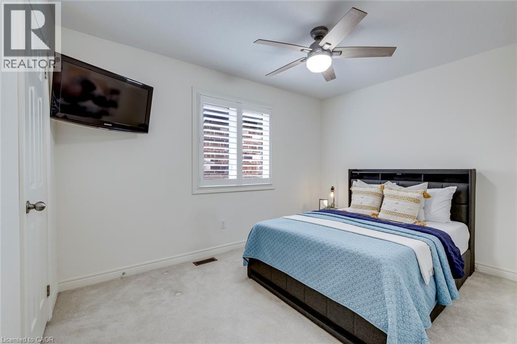 Bedroom featuring light-toned carpeting and white walls - 598 Bessborough Drive, Milton, ON - Indoor Photo Showing Bedroom