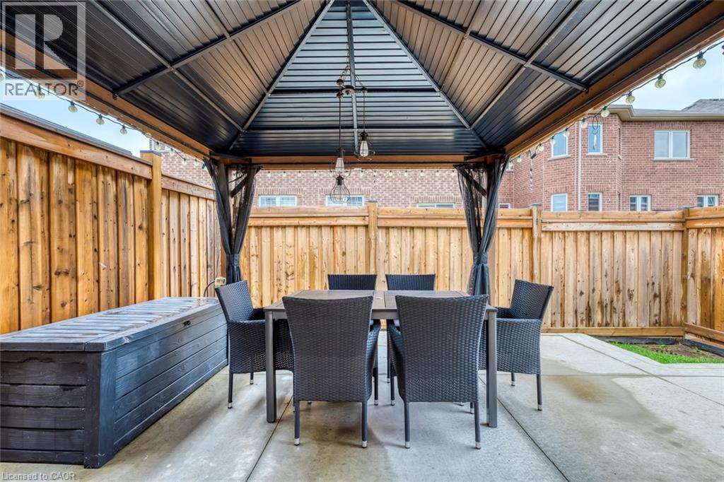 Private outdoor patio featuring a metal gazebo with string lighting - 598 Bessborough Drive, Milton, ON - Outdoor With Deck Patio Veranda With Exterior
