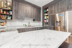 Beautiful cabinetry, lovely countertops & ss sink -