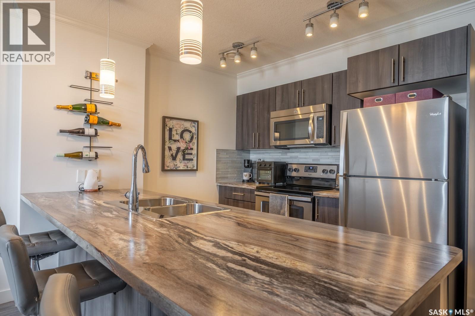 404 5301 Universal Crescent, Regina, SK - Indoor Photo Showing Kitchen With Stainless Steel Kitchen With Double Sink